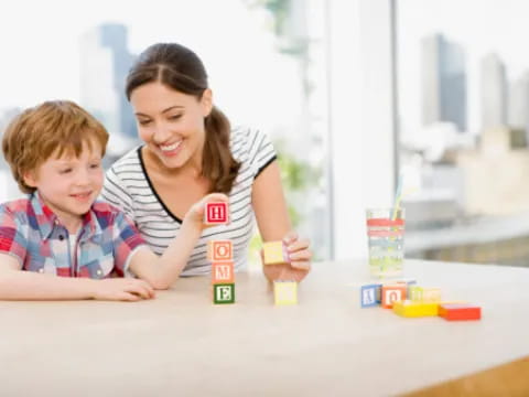 a person and a child playing with toys