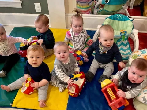 a group of children sitting on the floor with toys