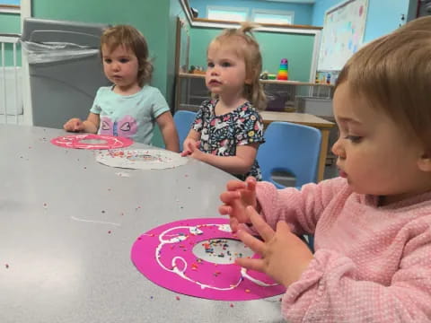 a group of children sitting at a table