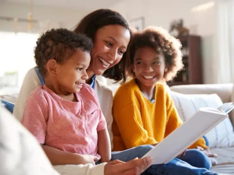 a family looking at a laptop