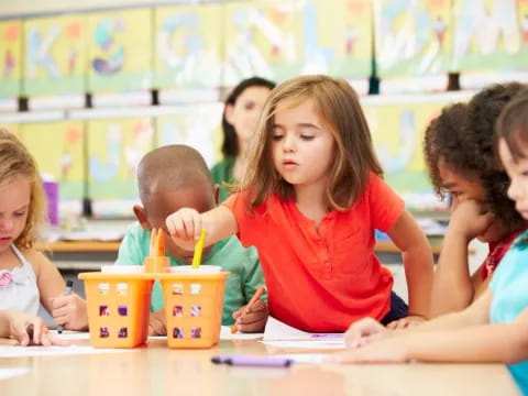 a group of children sitting at a table