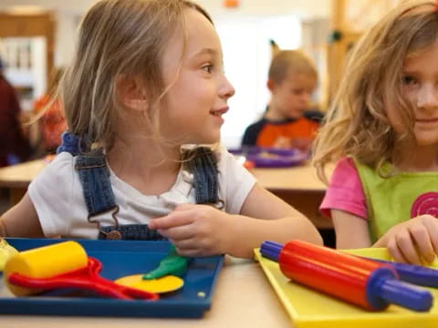 a few young girls sitting at a table