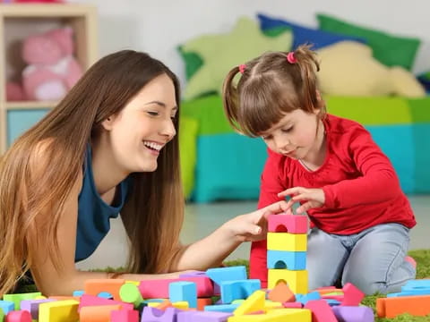 a woman and a child playing with toys