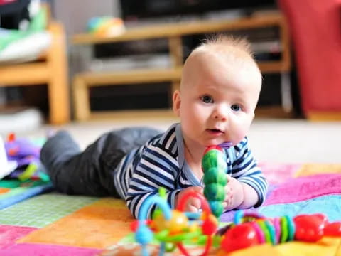 a baby lying on the floor