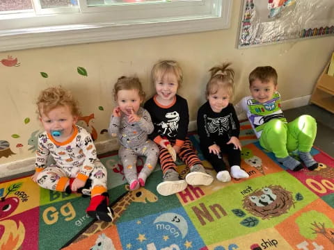 a group of children sitting on the floor