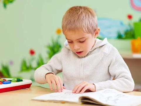 a child writing on a book