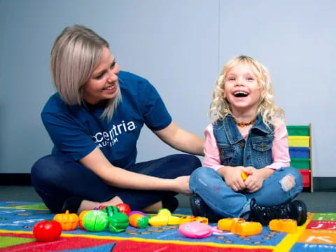 a person and a child playing with toys