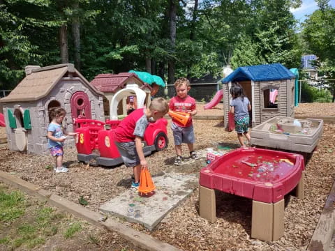 a person and kids playing in a play area