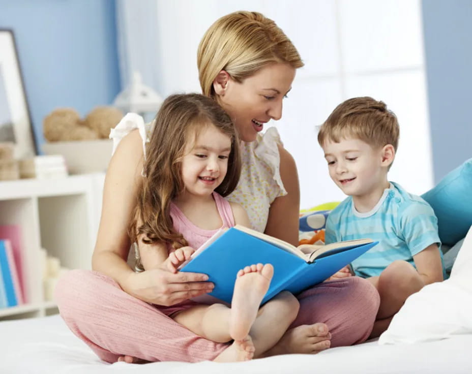 a person and two children reading a book