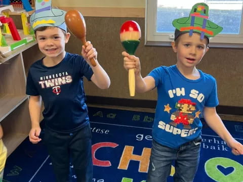 two boys wearing party hats