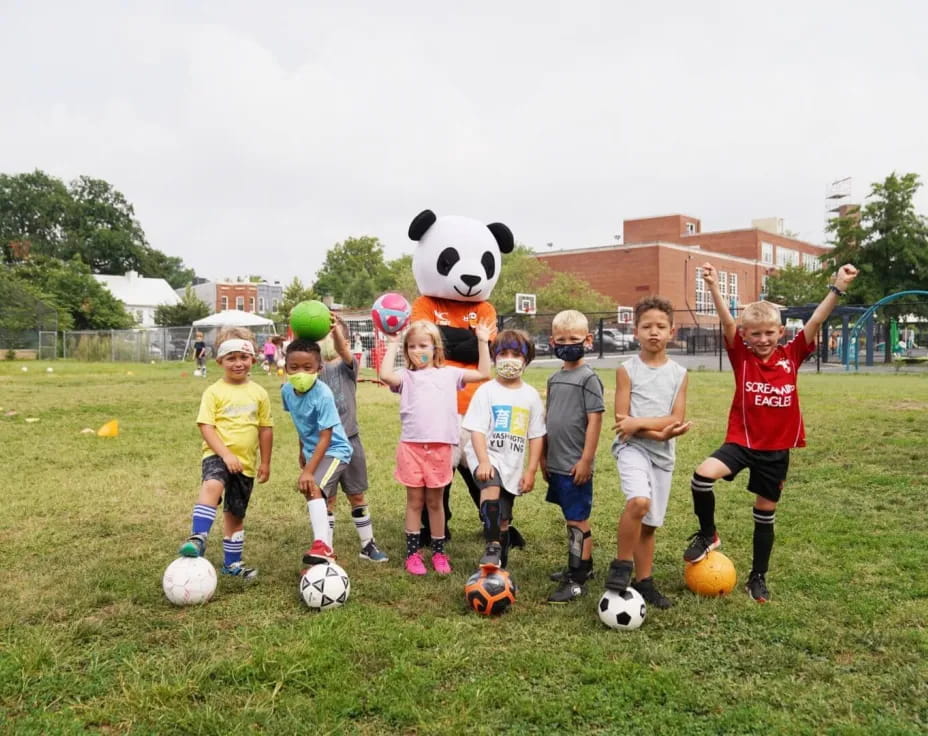 a group of kids playing football