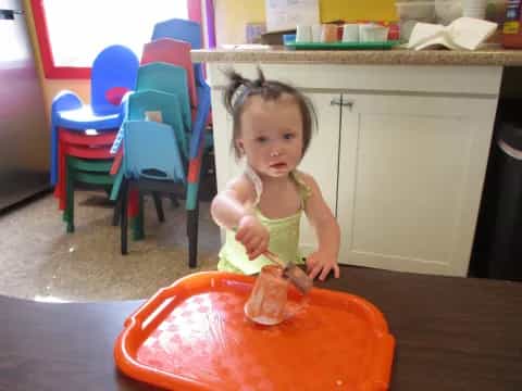 a little girl eating a cake