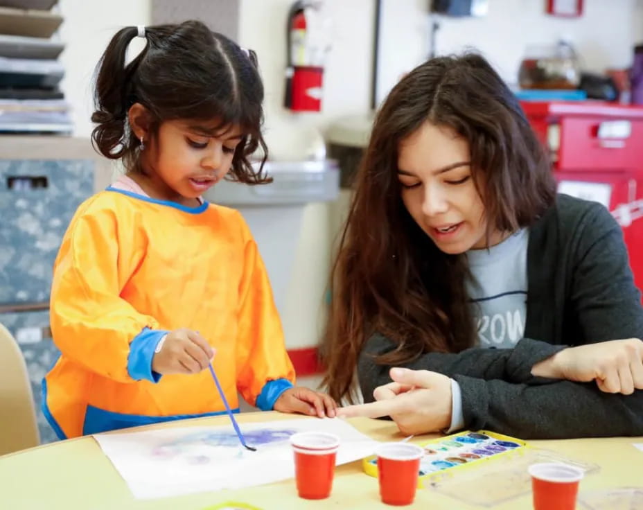 a woman and a child painting