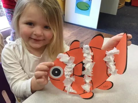 a girl holding a toy