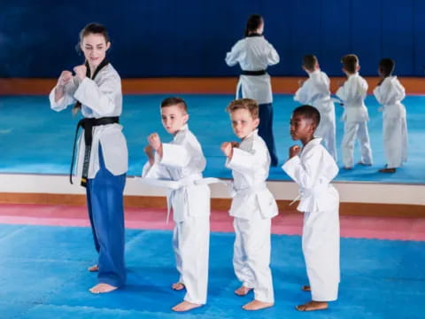 a group of children in karate uniforms