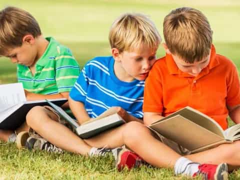 a group of boys reading books