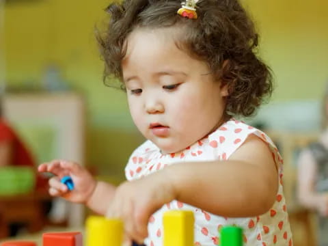 a little girl playing with a toy