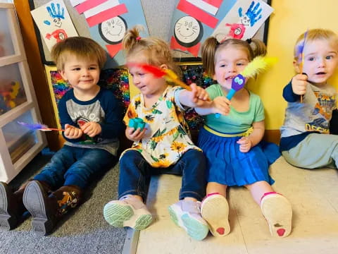 a group of kids sitting on the floor and eating