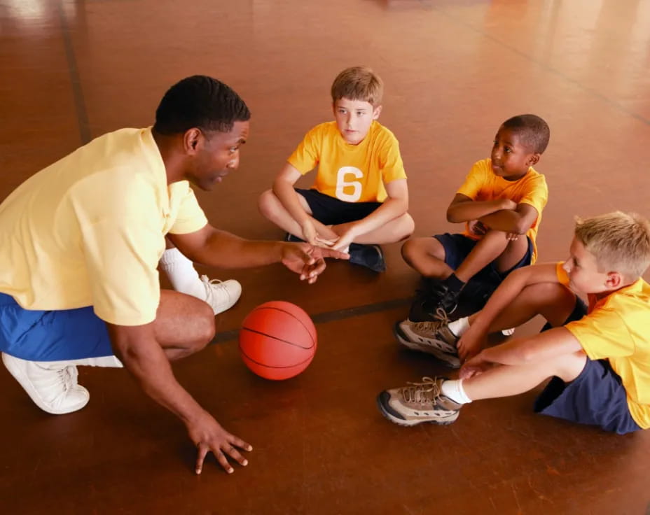 a group of boys playing basketball