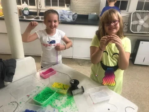 a couple of girls in a kitchen