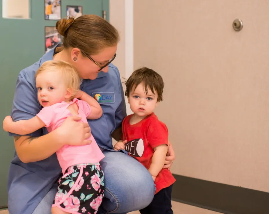 a person holding two children