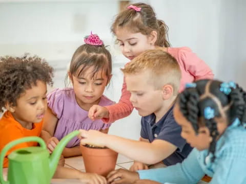 a group of children sitting at a table