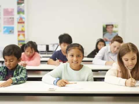 a group of children sitting at desks in a classroom