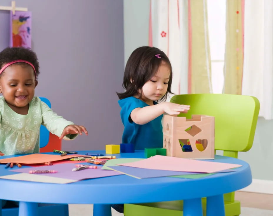 a couple of girls playing with a toy