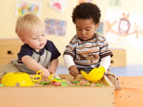 two boys playing with toys