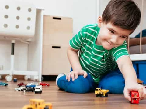 a boy playing with toys