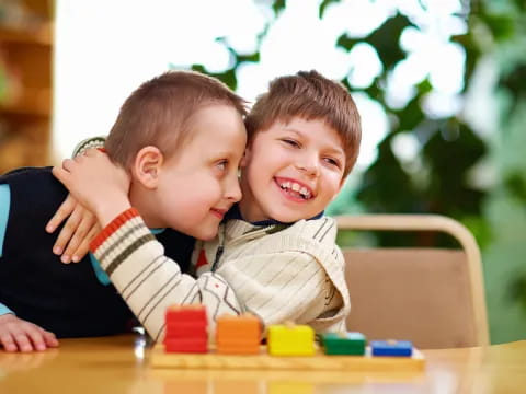 a couple of boys playing with blocks