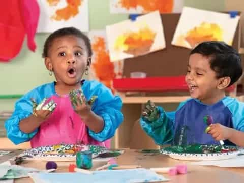 a couple of children eating ice cream