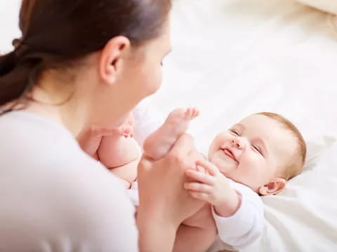 a woman holding a baby