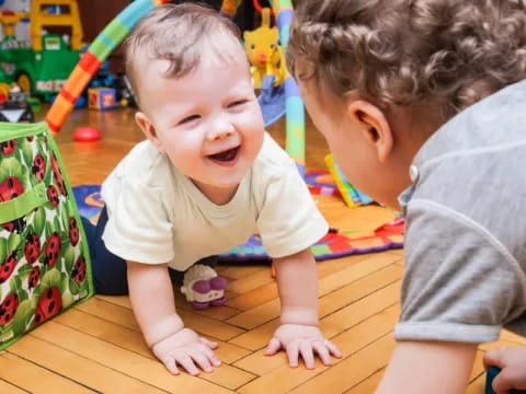 a couple of babies playing on the floor