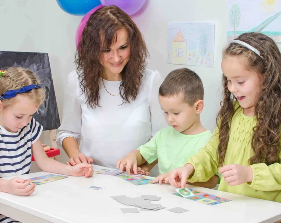 a group of children sitting at a table