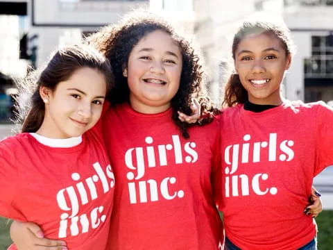 a group of girls in red shirts