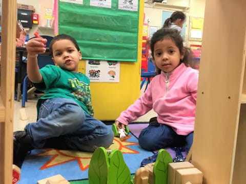 a couple of children sitting on the floor