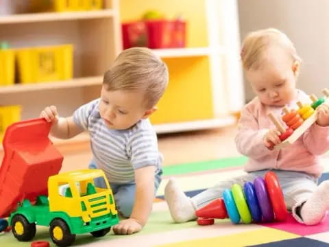 a couple of babies playing with toys