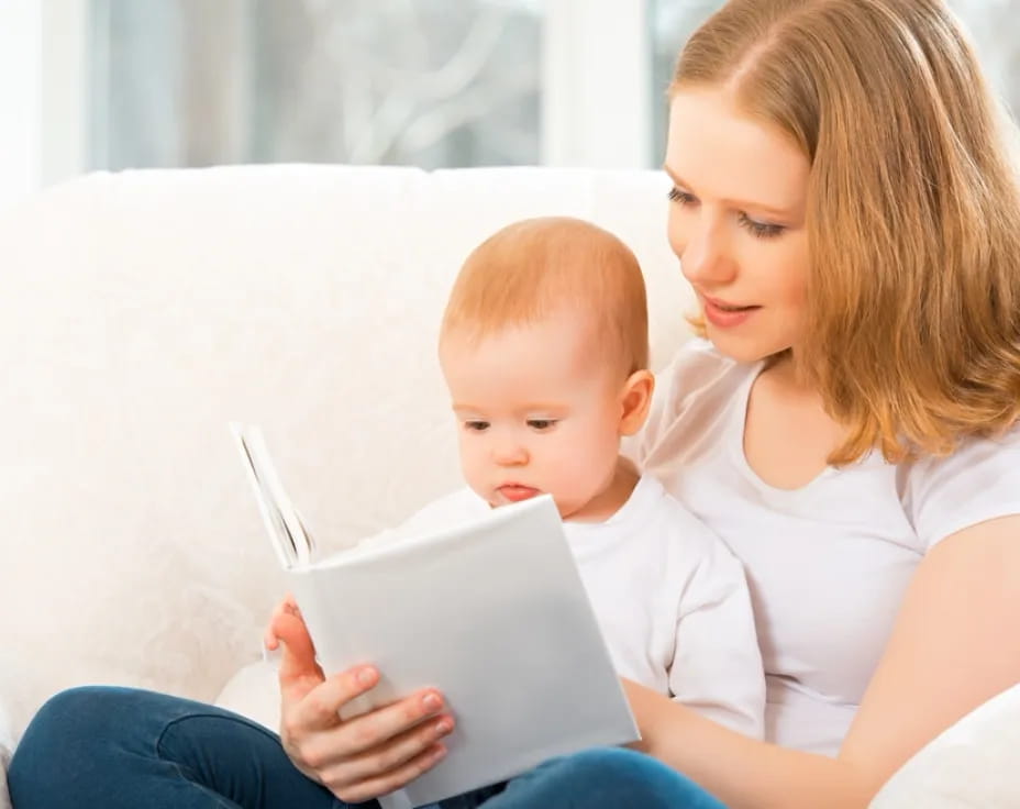 a person and a baby looking at a tablet