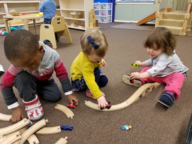 a group of children playing with toys