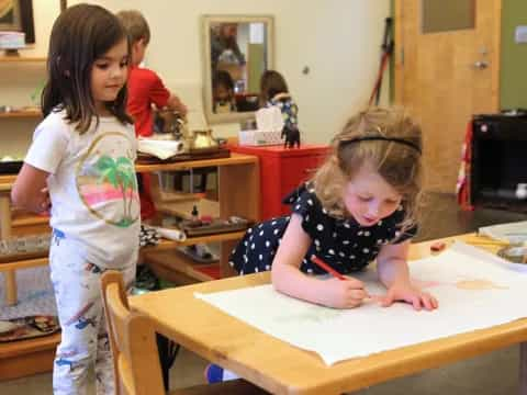 a few young girls in a classroom