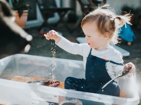 a little girl playing with water