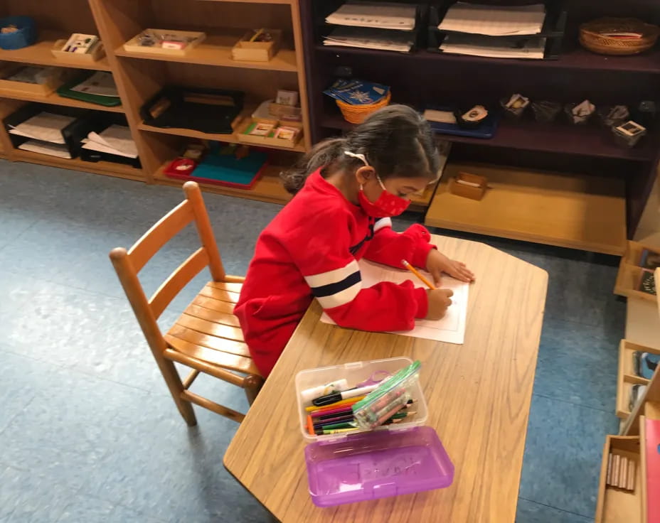 a girl sitting at a table