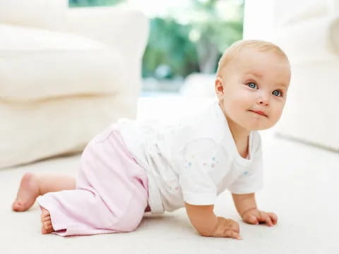 a baby lying on a bed