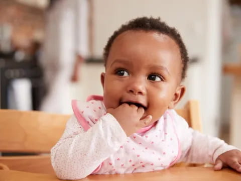 a baby with a finger in its mouth