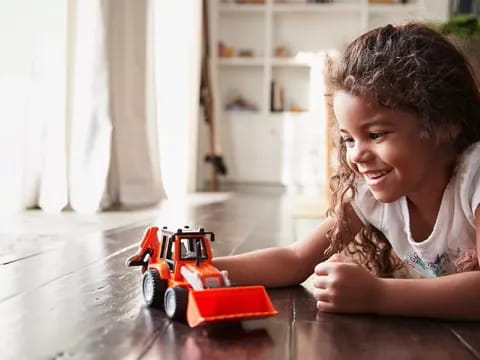 a child playing with a toy car