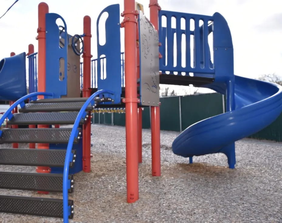 a playground with blue and red slide