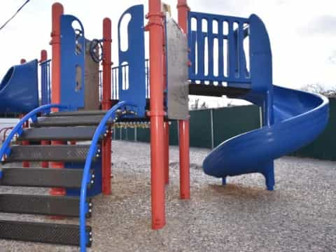 a playground with blue and red slide