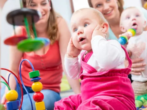 a group of people holding babies