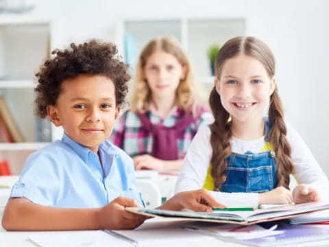 a few children sitting at a table